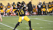 Jun 16, 2024; Hamilton, Ontario, CAN; Hamilton Tiger Cats quarterback Bo Levi Mitchell (19) throws a touchdown pass in the third quarter against the Saskatchewan Rough Riders at Tim Hortons Field. Mandatory Credit: Gerry Angus-Imagn Images