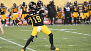 Jun 16, 2024; Hamilton, Ontario, CAN; Hamilton Tiger Cats quarterback Bo Levi Mitchell (19) throws a touchdown pass in the third quarter against the Saskatchewan Rough Riders at Tim Hortons Field. Mandatory Credit: Gerry Angus-Imagn Images