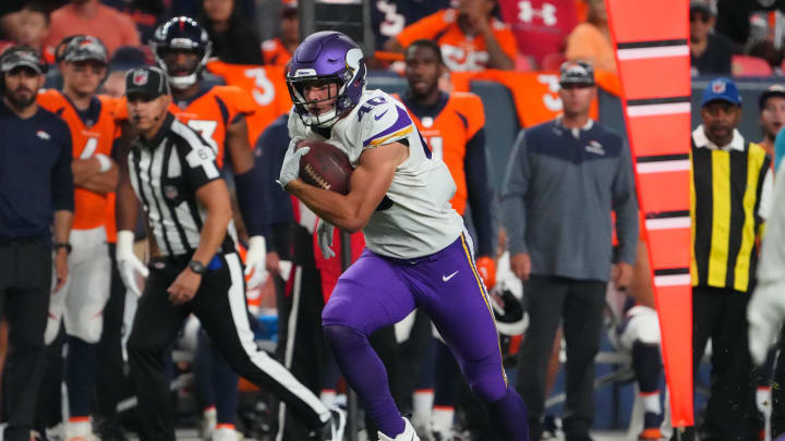 Aug 27, 2022; Denver, Colorado, USA; Minnesota Vikings tight end Zach Davidson (40) carries the ball against the Denver Broncos in the second half at Empower Field at Mile High.  