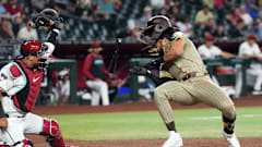 May 3, 2024; Phoenix, Arizona, USA; San Diego Padres outfielder Fernando Tatis Jr. (23) dodges a pitch from Scott McGough