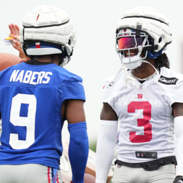 Jul 25, 2024; East Rutherford, NY, USA; New York Giants wide receiver Malik Nabers (9) and cornerback Deonte Banks (3) react after a drill during training camp at Quest Diagnostics Training Center.  
