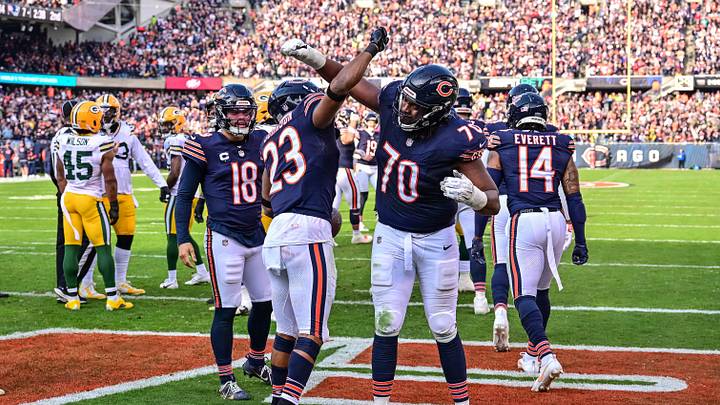 Nov 17, 2024; Chicago, Illinois, USA; Chicago Bears running back Roschon Johnson (23) celebrates his rushing touchdown with offensive tackle Braxton Jones (70) against the Green Bay Packers during the second quarter at Soldier Field. Mandatory Credit: Daniel Bartel-Imagn Images