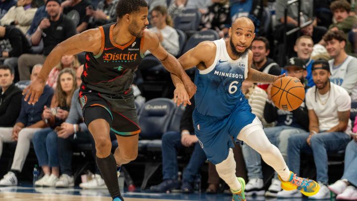 Apr 9, 2024; Minneapolis, Minnesota, USA; Minnesota Timberwolves guard Jordan McLaughlin (6) drives on Washington Wizards guard Jared Butler (4) in the third quarter at Target Center. Mandatory Credit: Matt Blewett-USA TODAY Sports