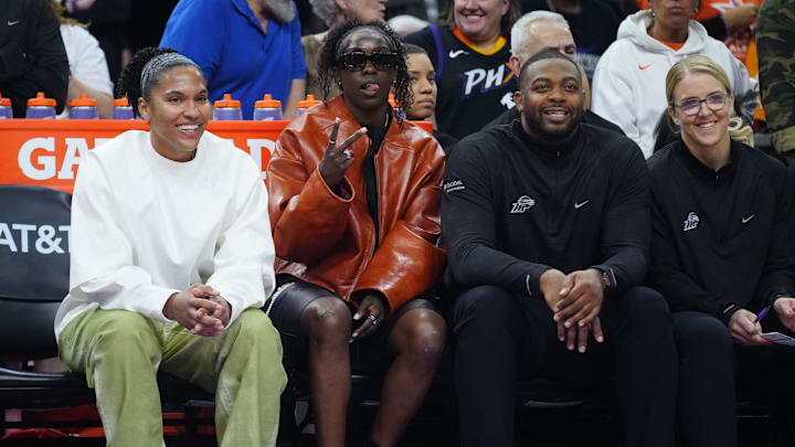 Mercury forward Alyssa Thomas (in white) and guard Kahleah Copper (brown jacket) on the bench during a game against the Lynx at PHX Arena in Phoenix, Ariz., on May 30, 2025.