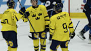 Aug 3, 2024; Plymouth, MI, USA; Sweden's defenseman Wilhelm Hallquisth (5) celebrates a goal against Finland with teammates during the second period of the 2024 World Junior Summer Showcase at USA Hockey Arena. Mandatory Credit: David Reginek-Imagn Images