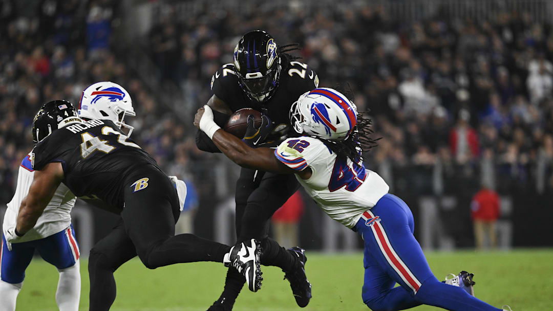 Sep 29, 2024; Baltimore, Maryland, USA;  Baltimore Ravens fullback Patrick Ricard (42) blocks Buffalo Bills safety Damar Hamlin (3) as  running back Derrick Henry (22) runs through linebacker Dorian Williams (42) tackle attempt during the second half at M&T Bank Stadium. Mandatory Credit: Tommy Gilligan-Imagn Images