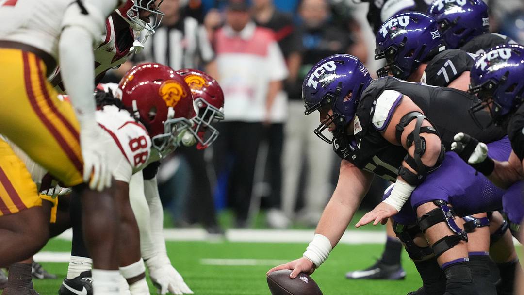 Helmets at the line of scrimmage as TCU Horned Frogs offensive lineman Coltin Deery (51) snaps the ball against the Southern California Trojans in the second half during the Alamo Bowl at Alamodome.