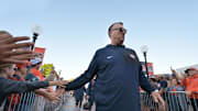 Sep 27, 2025; Champaign, Illinois, USA;  Illinois Fighting Illini head coach Bret Bielema leads his team down the Illini Walk before an NCAA football game with the Southern California Trojans at Memorial Stadium. Mandatory Credit: Ron Johnson-Imagn Images