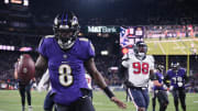 Jan 20, 2024; Baltimore, MD, USA; Baltimore Ravens quarterback Lamar Jackson (8) runs the ball to score a touchdown against Houston Texans defensive tackle Sheldon Rankins (98) during the fourth quarter of a 2024 AFC divisional round game at M&T Bank Stadium. Mandatory Credit: Tommy Gilligan-USA TODAY Sports