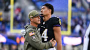 Oct 26, 2025; Baltimore, Maryland, USA; Baltimore Ravens head coach John Harbaugh greets Baltimore Ravens safety Kyle Hamilton (14) on the field after the game against the Chicago Bears at M&T Bank Stadium. Mandatory Credit: Tommy Gilligan-Imagn Images