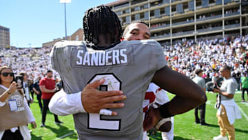 Sep 30, 2023; Boulder, Colorado, USA;  Colorado Buffaloes quarterback Shedeur Sanders (2) gets a hug
