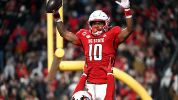 Nov 25, 2023; Raleigh, North Carolina, USA;North Carolina State Wolfpack receiver KC Concepcion (10) celebrates after a touchdown against the North Carolina Tar Heels during the first half at Carter-Finley Stadium. Mandatory Credit: Rob Kinnan-USA TODAY Sports