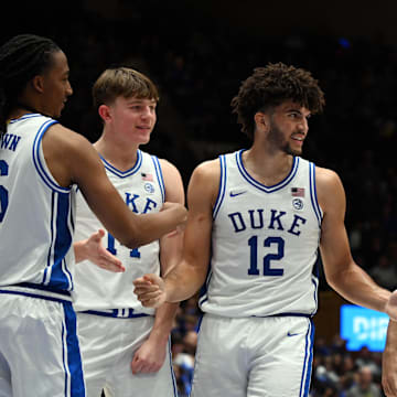 Nov 14, 2025; Durham, North Carolina, USA; Duke Blue Devils forward Cameron Boozer (12) is greeted by teammates after scoring during the second half against the Indiana State Sycamores at Cameron Indoor Stadium. Mandatory Credit: Rob Kinnan-Imagn Images