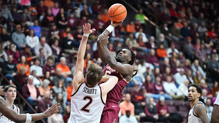 Feb 14, 2026; Blacksburg, Virginia, USA;  Florida State Seminoles guard Kobe Magee (5) shoots as Virginia Tech Hokies guard Jaden Schutt (2) defends during the first half at Cassell Coliseum. Mandatory Credit: Brian Bishop-Imagn Images