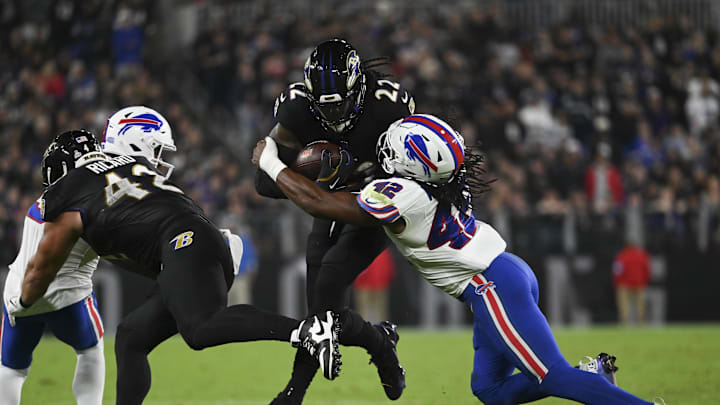Sep 29, 2024; Baltimore, Maryland, USA;  Baltimore Ravens fullback Patrick Ricard (42) blocks Buffalo Bills safety Damar Hamlin (3) as  running back Derrick Henry (22) runs through linebacker Dorian Williams (42) tackle attempt during the second half at M&T Bank Stadium. Mandatory Credit: Tommy Gilligan-Imagn Images