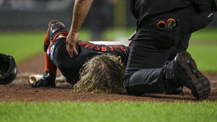 Jul 12, 2024; Baltimore, Maryland, USA;  Baltimore Orioles trainer Brain Ebal tends to  outfielder Heston Kjerstad (13) after being  hit by a pitch in the head during the ninth inning against the New York Yankees at Oriole Park at Camden Yards.