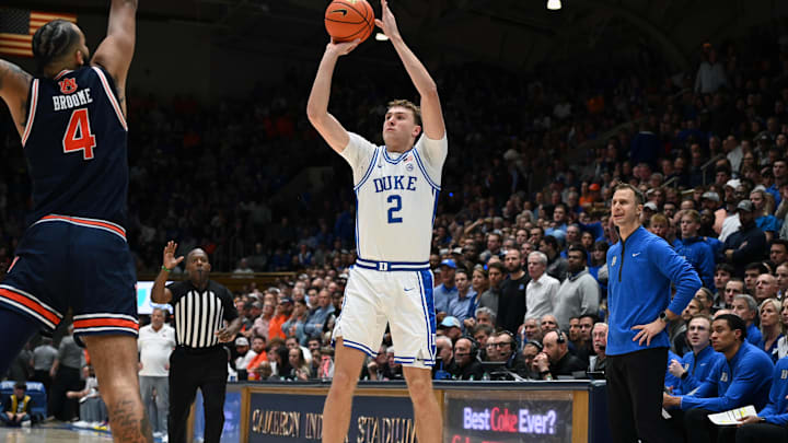 Dec 4, 2024; Durham, North Carolina, USA; Duke Blue Devils forward Cooper Flagg (2) shoots over Auburn Tigers center Johni Broome (4) during the second half at Cameron Indoor Stadium.  The Blue Devils won 84-78.   Mandatory Credit: Rob Kinnan-Imagn Images