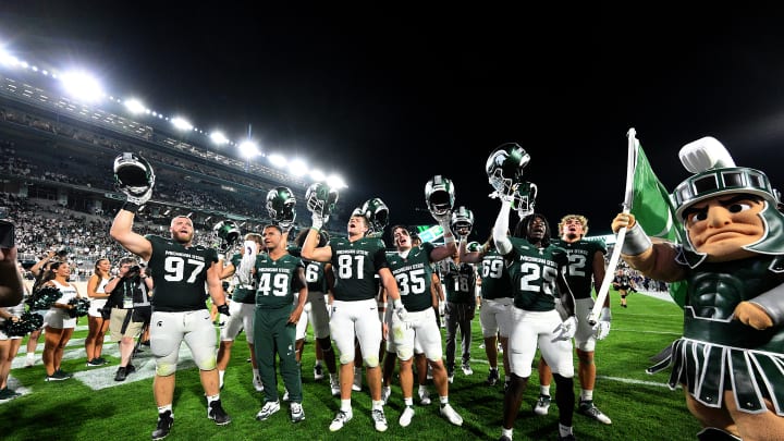 Aug 30, 2024; East Lansing, Michigan, USA;  Spartans celebrate their victory over the Florida Atlantic Owls by singing the fight song with the student section at Spartan Stadium. Mandatory Credit: Dale Young-USA TODAY Sports