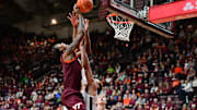 Feb 15, 2025; Blacksburg, Va.; Virginia Tech forward Tobi Lawal (1) shoots the ball as Virginia forward Elijah Saunders (2) defends.