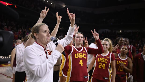 Feb 13, 2025; Los Angeles, California, USA; USC Trojans head coach Lindsay Gottlieb and her players celebrate defeating the U