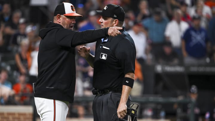 Jun 25, 2024; Baltimore, Maryland, USA;  Baltimore Orioles manager Brandon Hyde (18) argues a call with home plate umpire Dan Bellino (2) during the eighth inning against the Cleveland Guardians at Oriole Park at Camden Yards