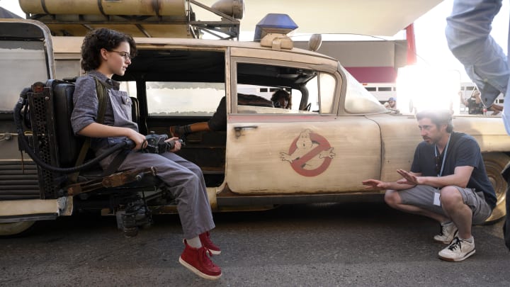 Director Jason Reitman with Mckenna Grace in the new Ecto-1 jumpseat on the set of GHOSTBUSTERS: AFTERLIFE.