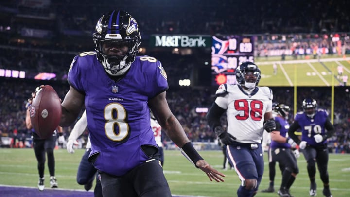 Jan 20, 2024; Baltimore, MD, USA; Baltimore Ravens quarterback Lamar Jackson (8) runs the ball to score a touchdown against Houston Texans defensive tackle Sheldon Rankins (98) during the fourth quarter of a 2024 AFC divisional round game at M&T Bank Stadium. Mandatory Credit: Tommy Gilligan-USA TODAY Sports