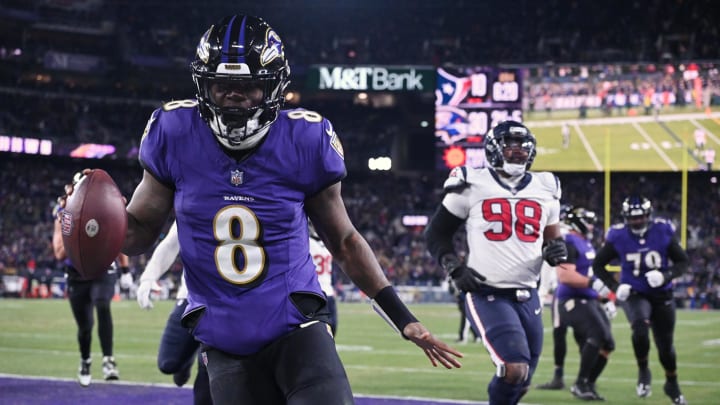 Jan 20, 2024; Baltimore, MD, USA; Baltimore Ravens quarterback Lamar Jackson (8) runs the ball to score a touchdown against Houston Texans defensive tackle Sheldon Rankins (98) during the fourth quarter of a 2024 AFC divisional round game at M&T Bank Stadium. Mandatory Credit: Tommy Gilligan-USA TODAY Sports