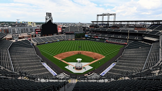 A wide view of Coors Field from above field level, as batting practice takes place. 
