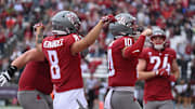 Oct 19, 2024; Pullman, Washington, USA; Washington State Cougars quarterback John Mateer (10) and Washington State Cougars wide receiver Carlos Hernandez (8) celebrate a touchdown against the Hawaii Warriors in the second half at Gesa Field at Martin Stadium. Mandatory Credit: James Snook-Imagn Images