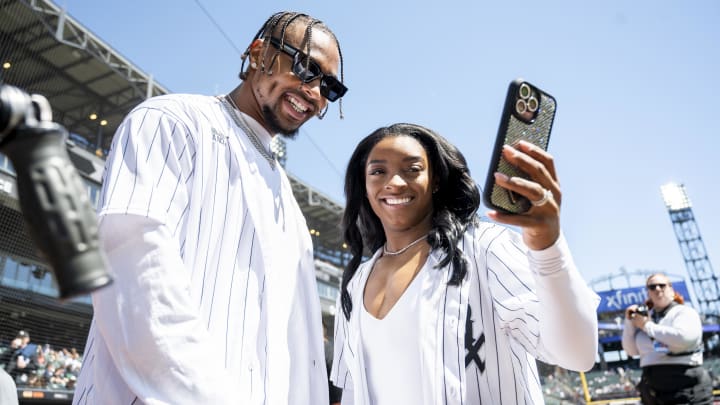 Apr 13, 2024; Chicago, Illinois, USA; Chicago Bears safety Jonathan Owens and American gymnast Simone Biles take a selfie prior to a game between the Chicago White Sox and the Cincinnati Reds at Guaranteed Rate Field. 