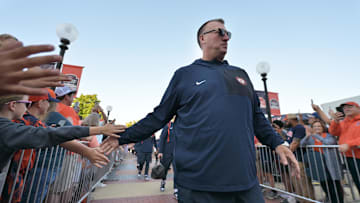 Sep 27, 2025; Champaign, Illinois, USA;  Illinois Fighting Illini head coach Bret Bielema leads his team down the Illini Walk before an NCAA football game with the Southern California Trojans at Memorial Stadium. Mandatory Credit: Ron Johnson-Imagn Images