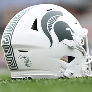 Sep 7, 2024; College Park, Maryland, USA; A detailed view of Michigan State Spartans helmet on the field before the game against the Maryland Terrapins at SECU Stadium. Mandatory Credit: Tommy Gilligan-Imagn Images