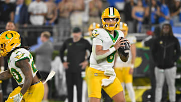 Sep 28, 2024; Pasadena, California, USA; Oregon Ducks quarterback Dillon Gabriel (8) loos for a receiver during the seconds quarter against the UCLA Bruins at Rose Bowl. Mandatory Credit: Robert Hanashiro-Imagn Images