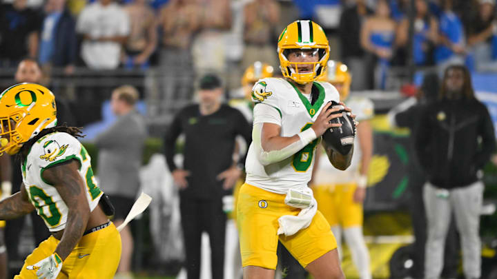 Sep 28, 2024; Pasadena, California, USA; Oregon Ducks quarterback Dillon Gabriel (8) loos for a receiver during the seconds quarter against the UCLA Bruins at Rose Bowl. Mandatory Credit: Robert Hanashiro-Imagn Images
