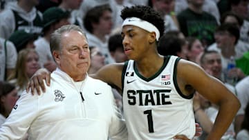 Mar 9, 2025; East Lansing, Michigan, USA;  Michigan State Spartans head coach Tom Izzo huddles with Michigan State Spartans guard Jeremy Fears Jr. (1) during the second half against the Michigan Wolverines at Jack Breslin Student Events Center. Mandatory Credit: Dale Young-Imagn Images