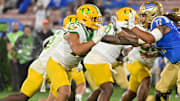 Oregon Ducks defensive end Matayo Uiagalelei and UCLA Bruins offensive lineman Jaylan Jeffers battle at the line of scrimmage.