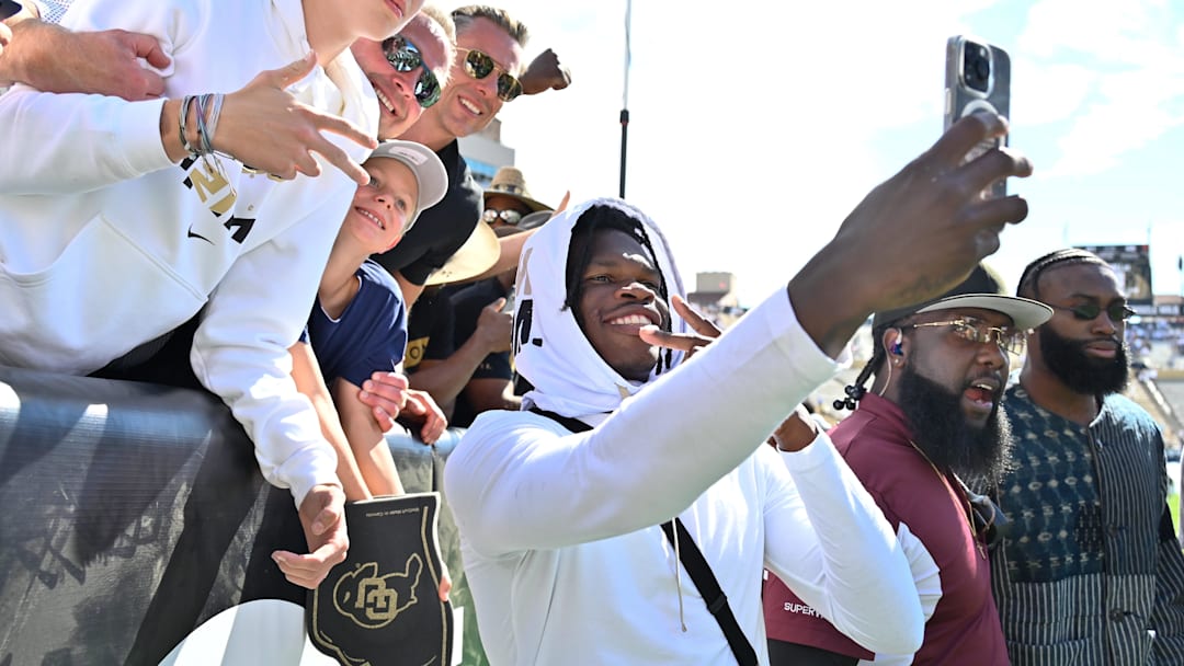 Sep 30, 2023; Boulder, Colorado, USA; Colorado Buffaloes cornerback Travis Hunter (12) takes selfies with fans after the game against the USC Trojans at Folsom Field. Mandatory Credit: John Leyba-USA TODAY Sports