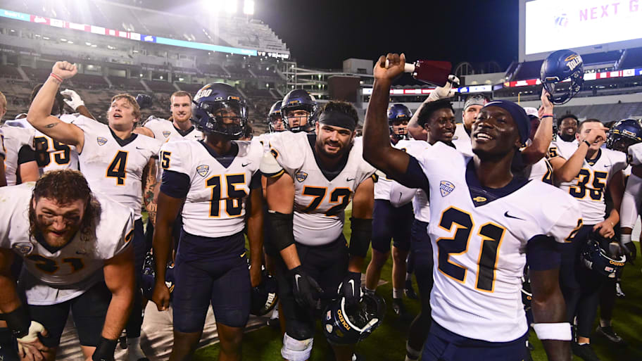 Toledo players celebrate after defeating Mississippi State.