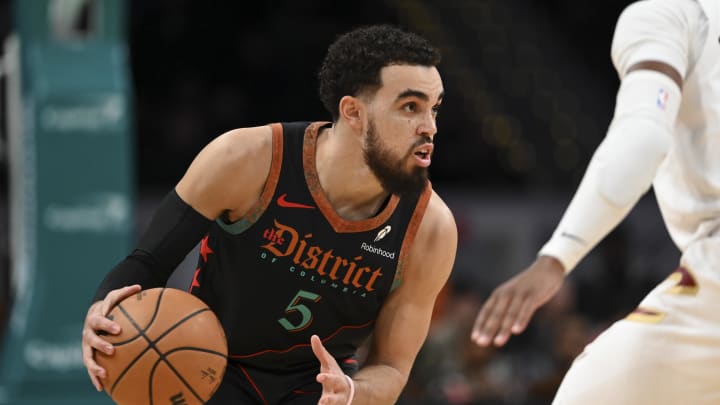 Feb 25, 2024; Washington, District of Columbia, USA; Washington Wizards guard Tyus Jones (5) dribbles as Cleveland Cavaliers guard Darius Garland (10) defends  during the second  half at Capital One Arena. Mandatory Credit: Tommy Gilligan-USA TODAY Sports