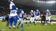 Nov 9, 2025; Berlin, Germany; Indianapolis Colts running back Jonathan Taylor (28) celebrates with teammates and mascot after a touchdown against the Atlanta Falcons during the NFL Berlin Game at Olympic Stadium. 