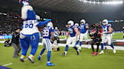 Nov 9, 2025; Berlin, Germany; Indianapolis Colts running back Jonathan Taylor (28) celebrates with teammates and mascot after a touchdown against the Atlanta Falcons during the NFL Berlin Game at Olympic Stadium. 