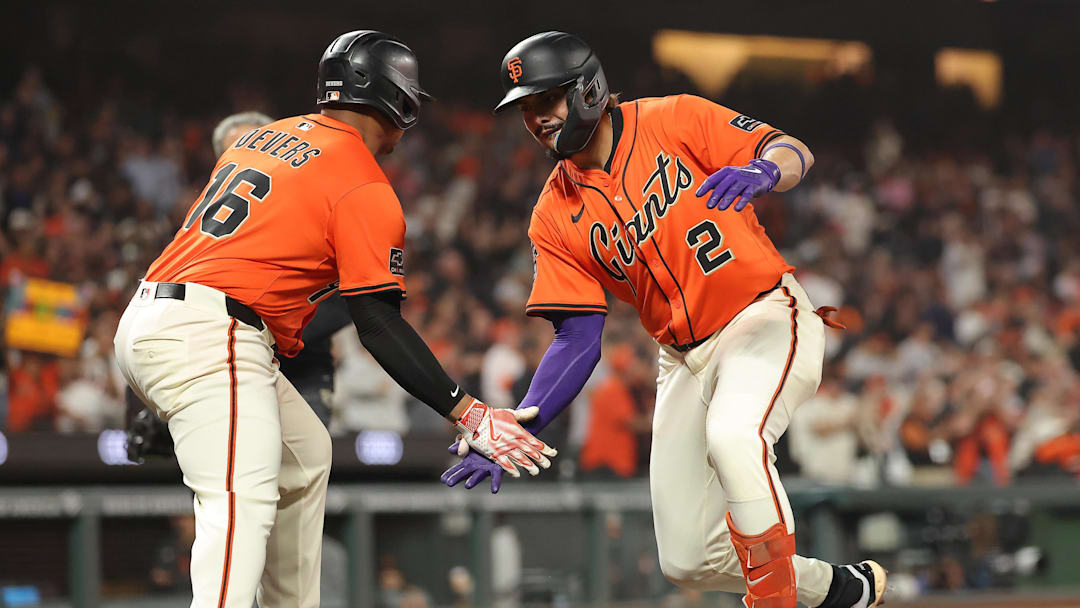 Sep 26, 2025; San Francisco, California, USA; San Francisco Giants shortstop Willy Adames (2) high fives designated hitter Rafael Devers (16) after batting him in on a two-run home run against the Colorado Rockies during the first inning at Oracle Park. Mandatory Credit: Kelley L Cox-Imagn Images