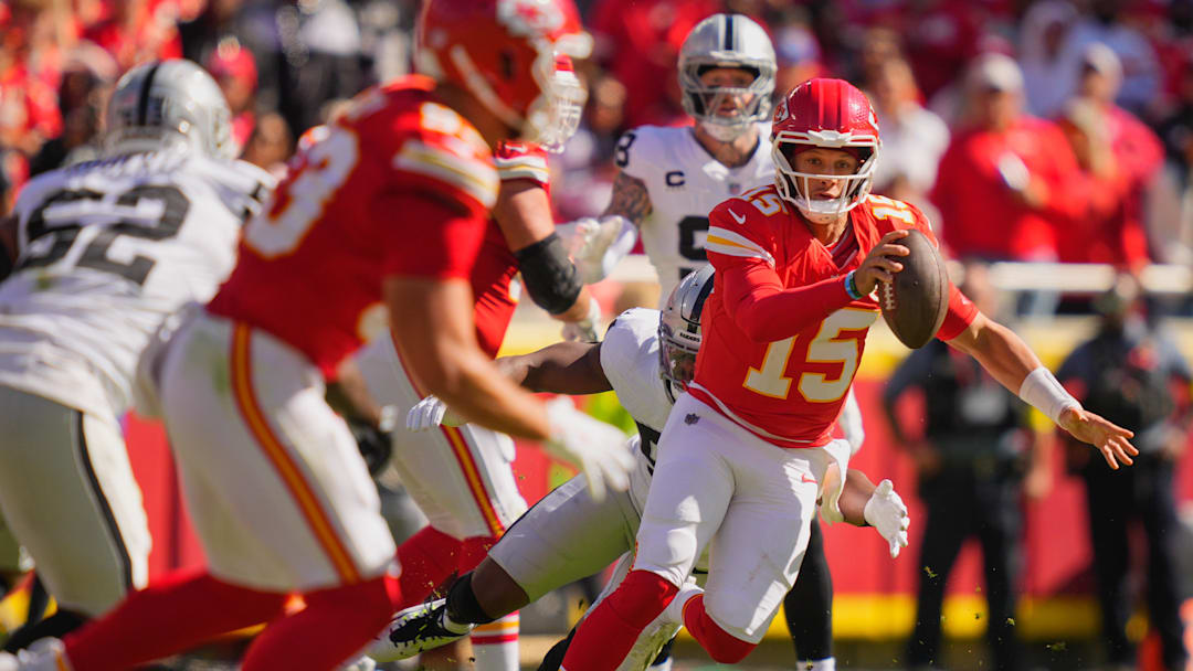 Oct 19, 2025; Kansas City, Missouri, USA; Kansas City Chiefs quarterback Patrick Mahomes (15) scrambles with the ball against the Las Vegas Raiders during the second quarter of the game at GEHA Field at Arrowhead Stadium. Mandatory Credit: Jay Biggerstaff-Imagn Images