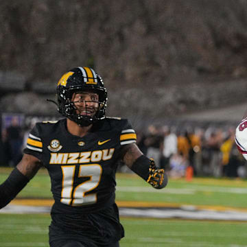 Sep 20, 2025; Columbia, Missouri, USA; South Carolina Gamecocks wide receiver Brian Rowe Jr. (18) catches a pass for a touchdown as Missouri Tigers cornerback Drey Norwood (12) looks on during the first half of the game at Faurot Field at Memorial Stadium. Mandatory Credit: Denny Medley-Imagn Images