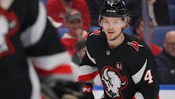 Mar 12, 2024; Buffalo, New York, USA;  Buffalo Sabres defenseman Bowen Byram (4) looks for the puck during the first period against the Detroit Red Wings at KeyBank Center. Mandatory Credit: Timothy T. Ludwig-Imagn Images
