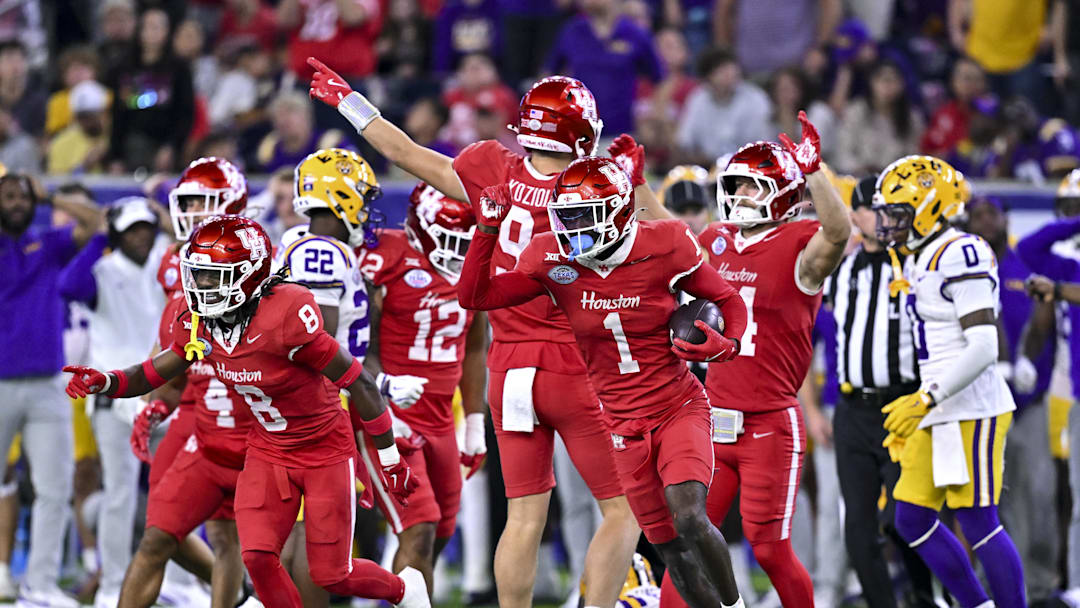Dec 27, 2025; Houston, TX, USA; Houston Cougars defensive back Latrell McCutchin Sr. (1) recovers the onside kick during the second half against the Louisiana State Tigers at NRG Stadium. Mandatory Credit: Maria Lysaker-Imagn Images 
