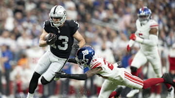 November 5, 2023; Paradise, Nevada, USA; Las Vegas Raiders wide receiver Hunter Renfrow (13) is tackled by New York Giants cornerback Cor'Dale Flott (28) during the second quarter at Allegiant Stadium. Mandatory Credit: Kyle Terada-Imagn Images