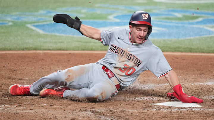 Sep 3, 2024; Miami, Florida, USA;  Washington Nationals center fielder Jacob Young (30) slides safely into home plate against the Miami Marlins in the ninth inning at loanDepot Park.