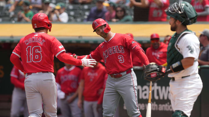 Jul 21, 2024; Oakland, California, USA; Los Angeles Angels center fielder Mickey Moniak (16) is congratulated by left fielder Taylor Ward (3) after hitting a home run against the Oakland Athletics during the fifth inning at Oakland-Alameda County Coliseum. Mandatory Credit: Darren Yamashita-USA TODAY Sports